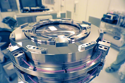 Large cylindrical metal part of a lithography industrial machine.